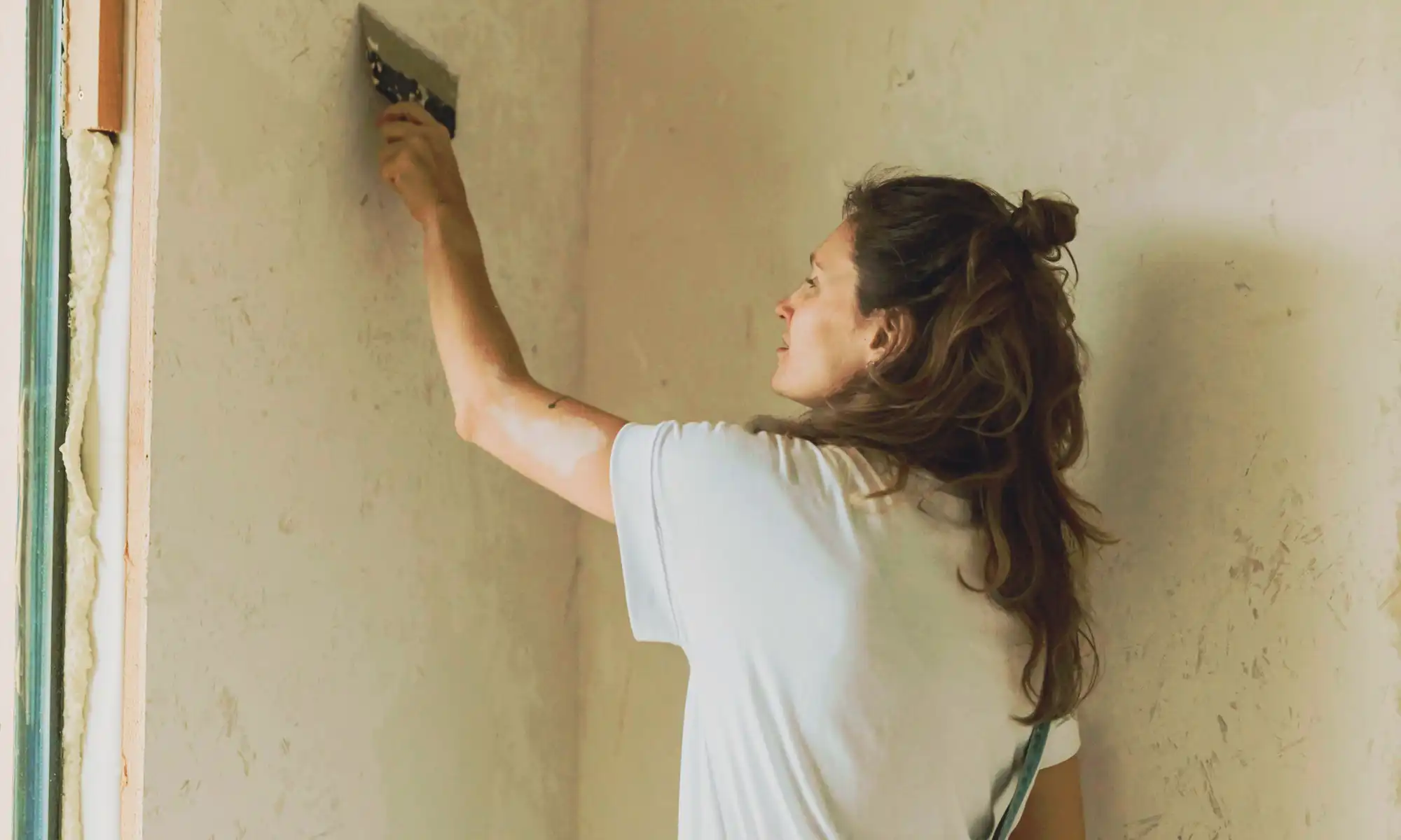 Nancy fixing wall.webp